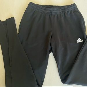 Black adidas sweatpants with zipper at the ankle